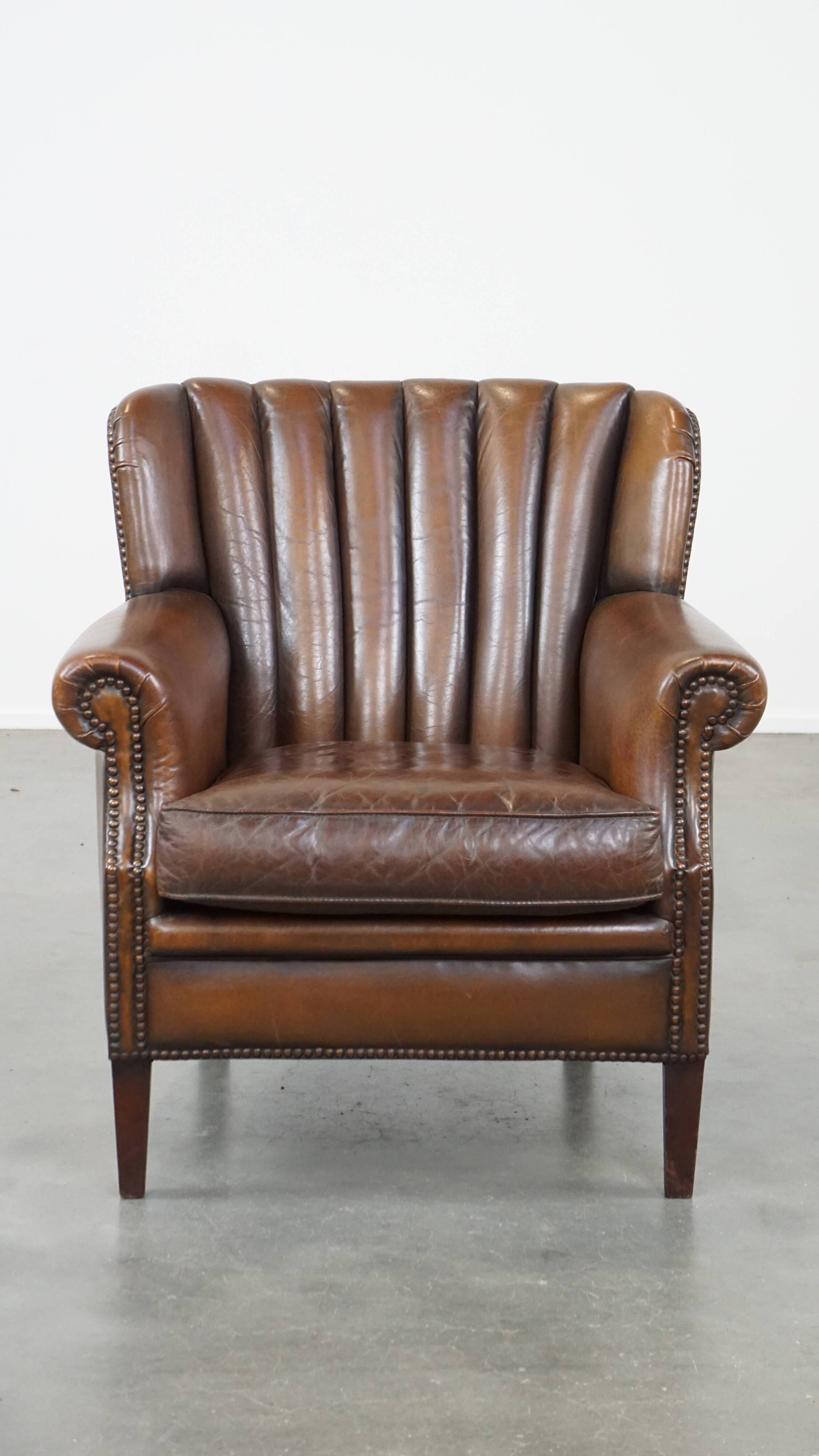 Sheep leather armchair finished with decorative nails