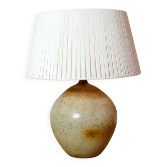 Large stone lamp with a cotton shade.