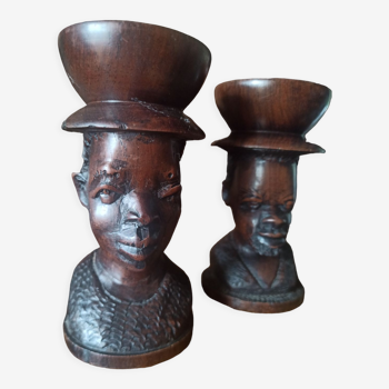 Bed of ethnic candlesticks African heads