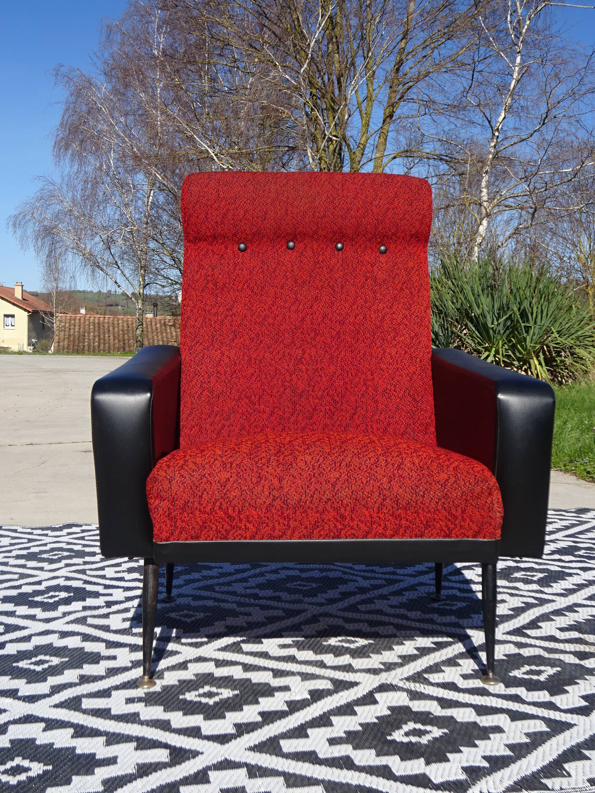 Vintage armchairs in red and black faux leather, the pair.