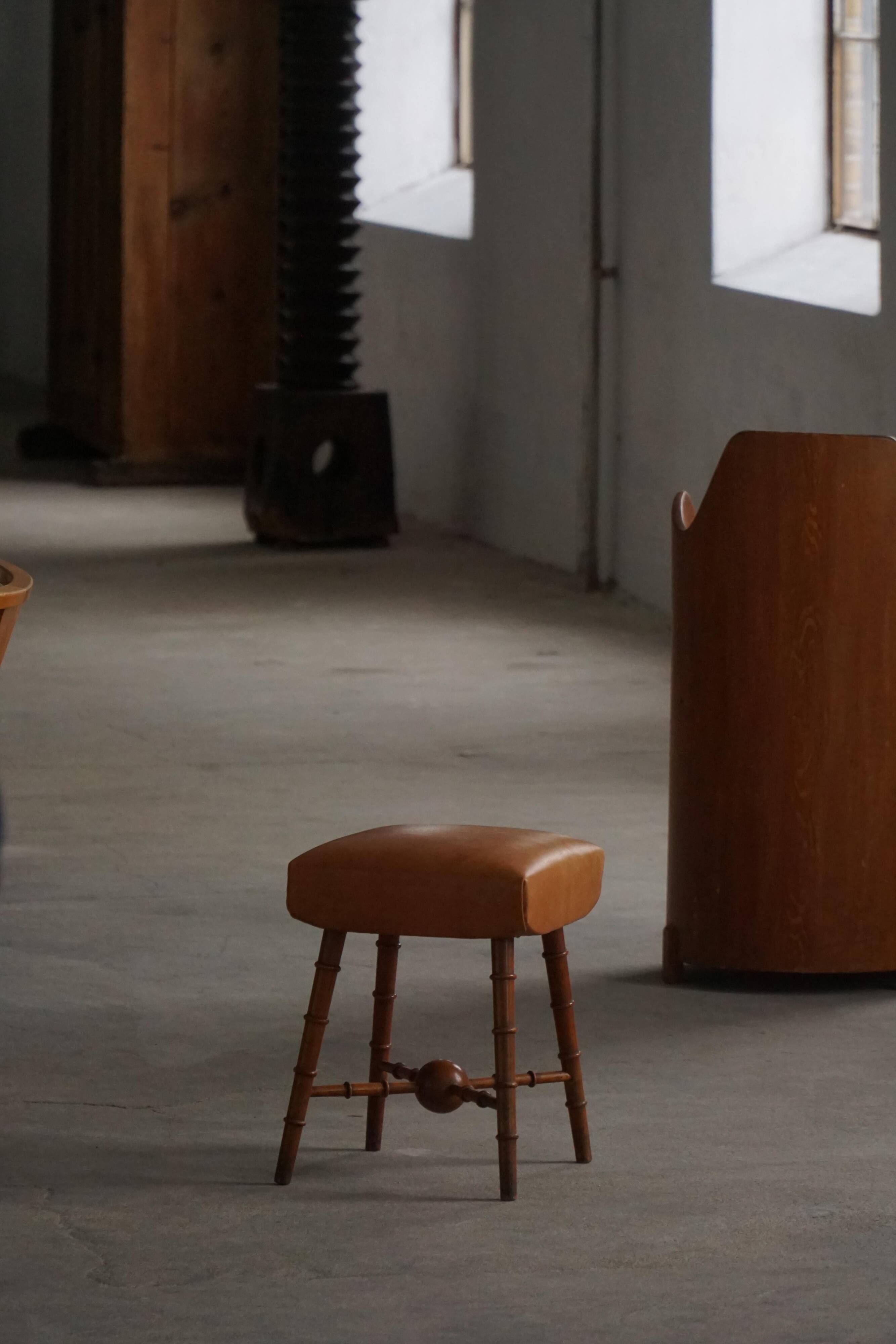 Turned wooden stool with leather seat, mid-20th century, Danish modern.