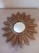 Miroir soleil vintage , en bois doré .