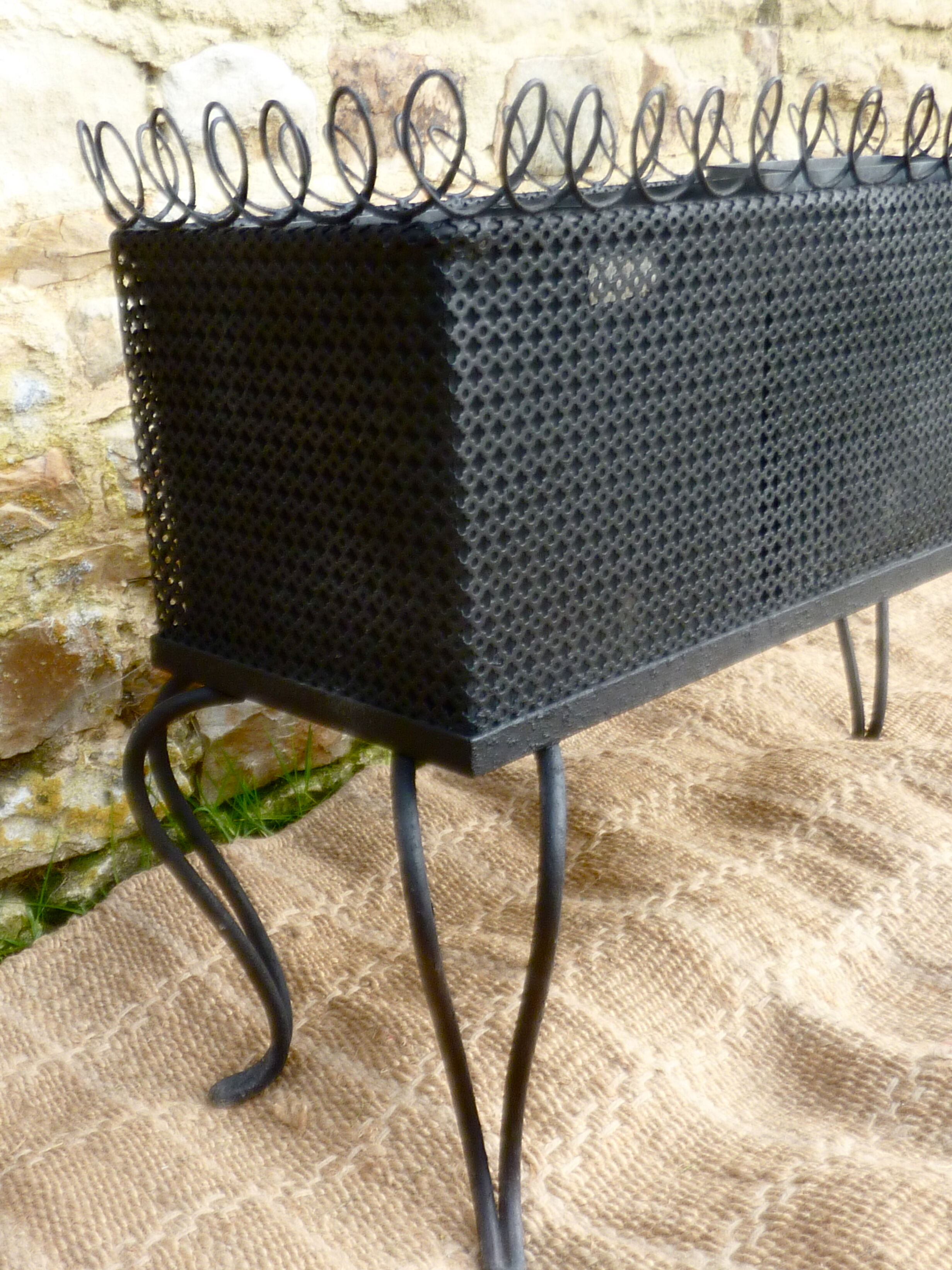 Black perforated metal planter from the 1950s
