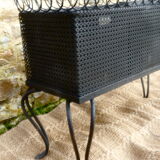 Black perforated metal planter from the 1950s