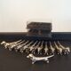 Series of 12 vintage dachshund knife holders in silver metal