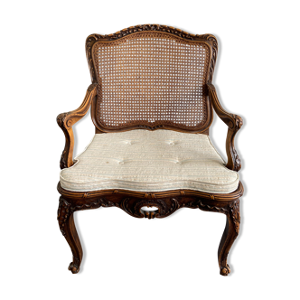 Fauteuil canné Régence en noyer sculpté