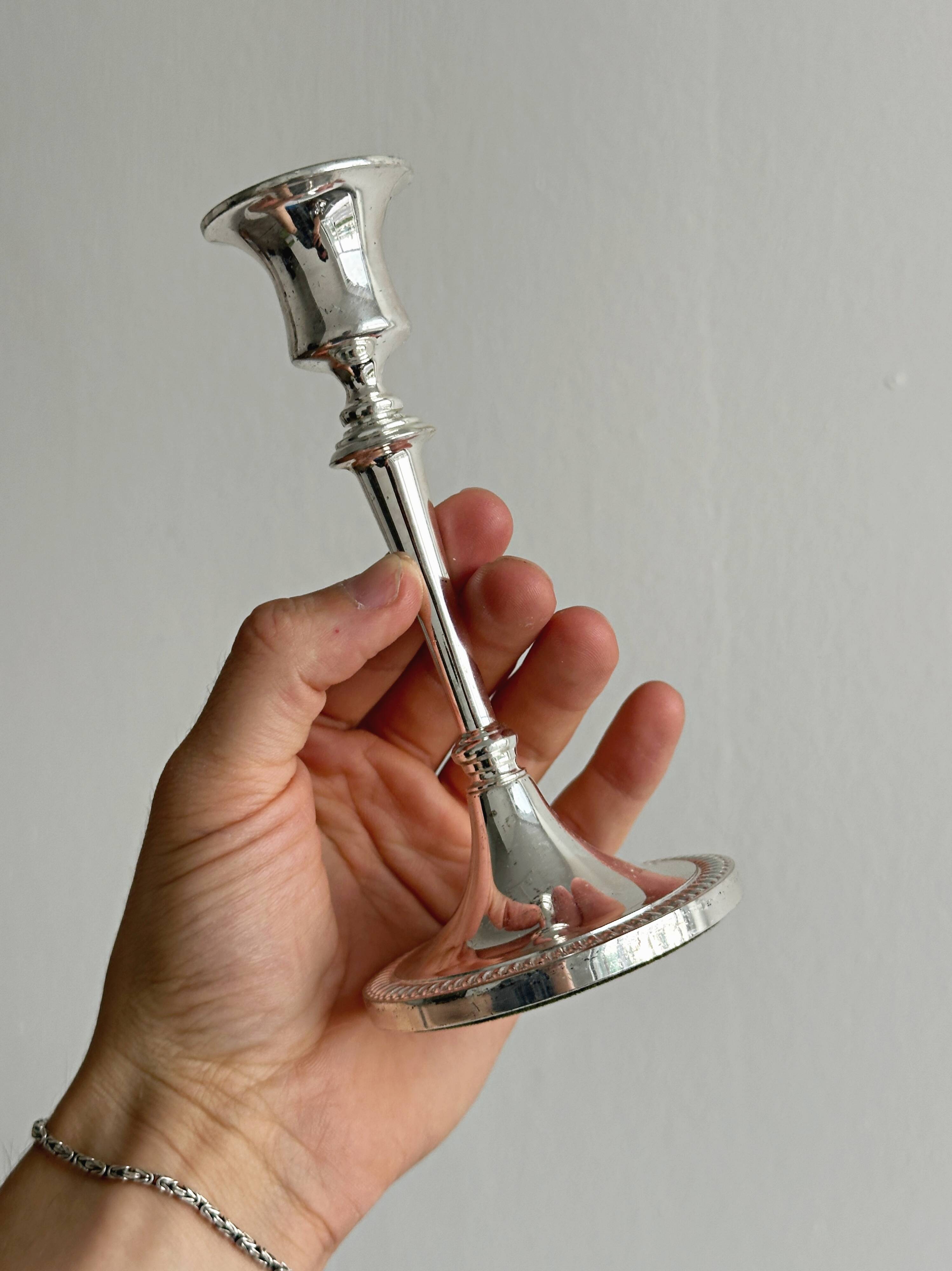 Pair of white metal candlesticks