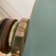 Small vintage wooden turned table lamp with a pleated shade.