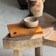 Small rectangular teak monoxyle cutting board with a circular handle.