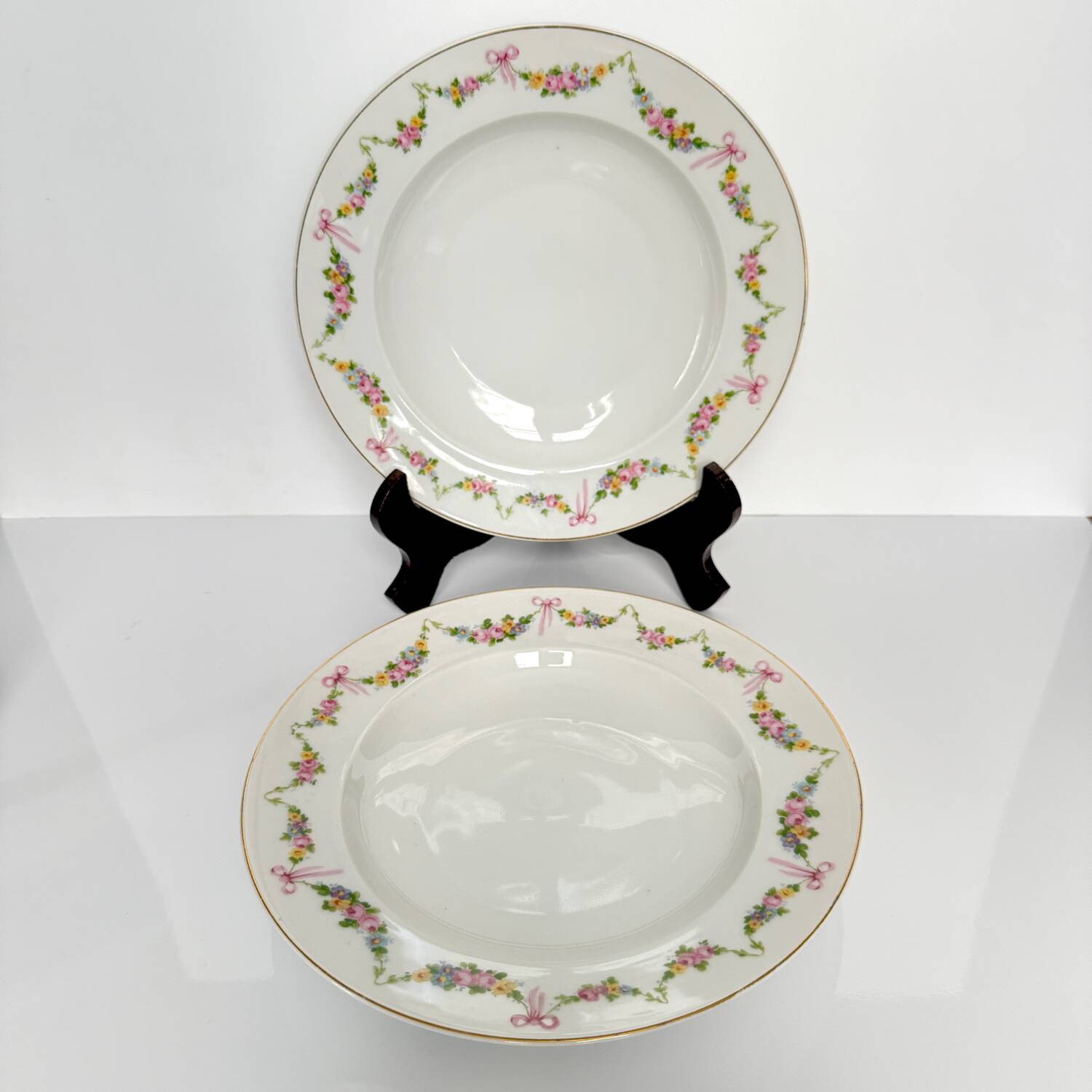 Pair of soup plates by EPIAG | ribbons/bows and garlands