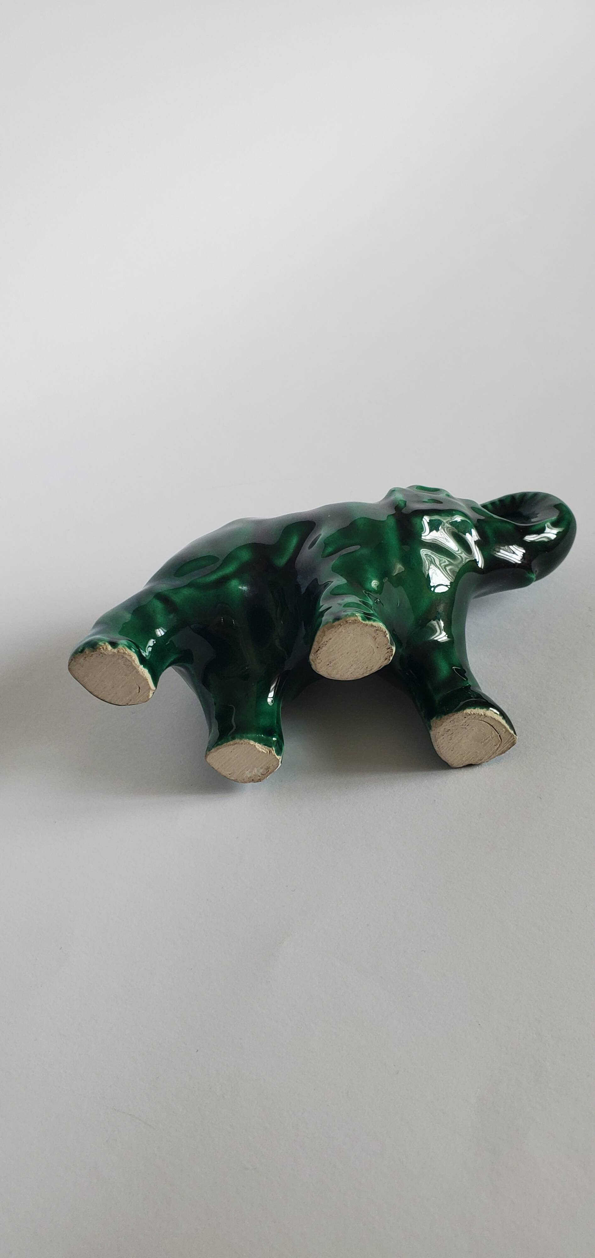 Small emerald green ceramic elephant.