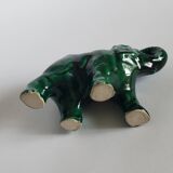 Small emerald green ceramic elephant.