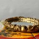 Small vintage oval wall mirror in varnished gold resin