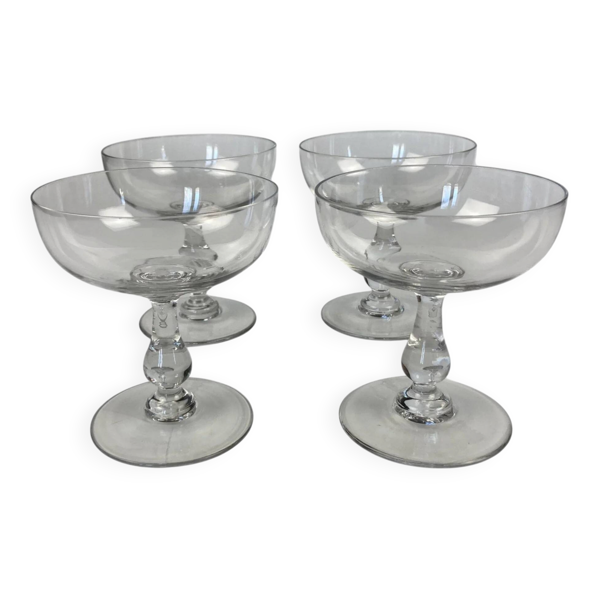 4 Baccarat crystal champagne coupes in a gondola shape.