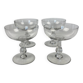 4 Baccarat crystal champagne coupes in a gondola shape.