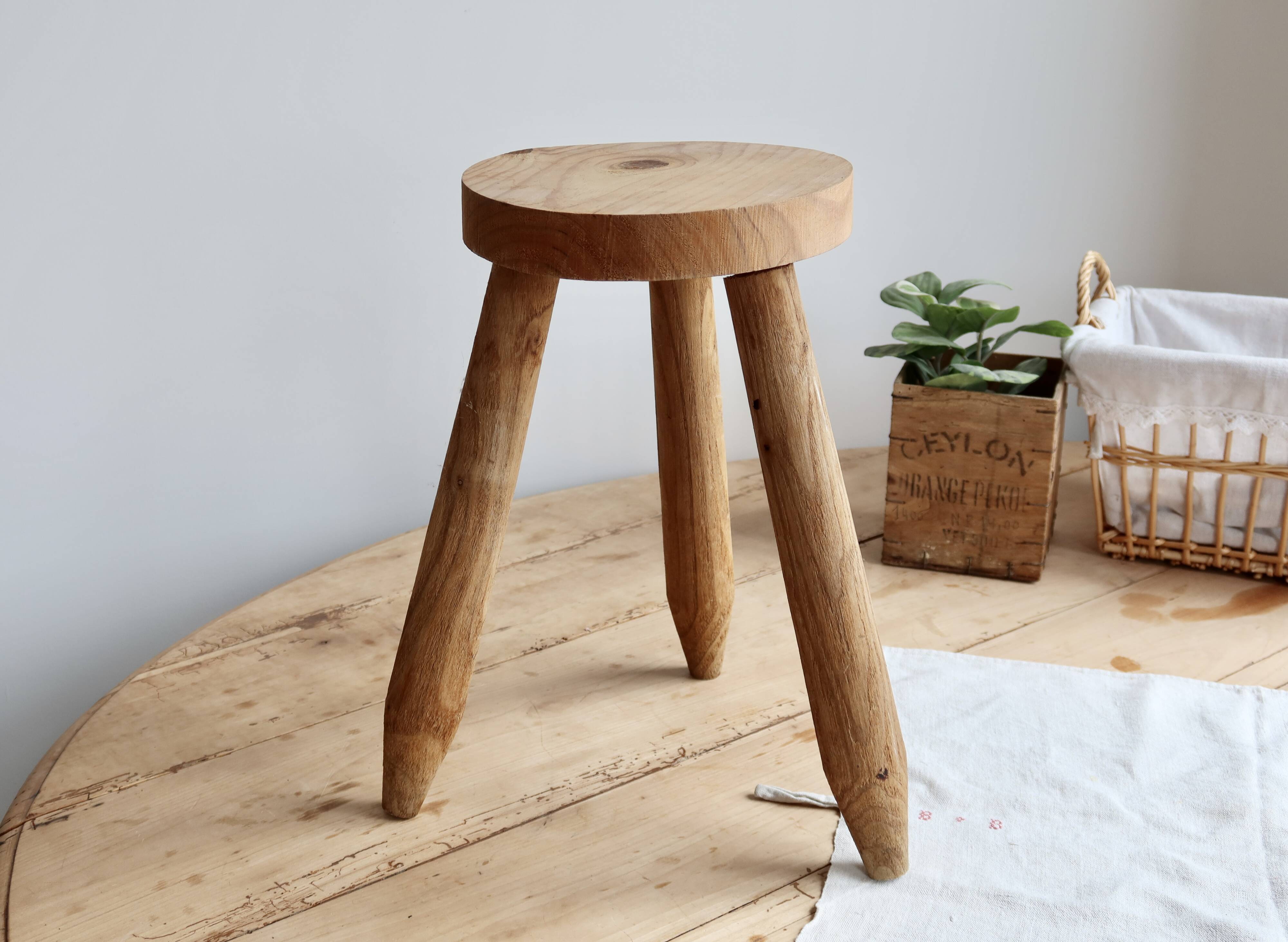 Vintage tripod stool in light raw wood