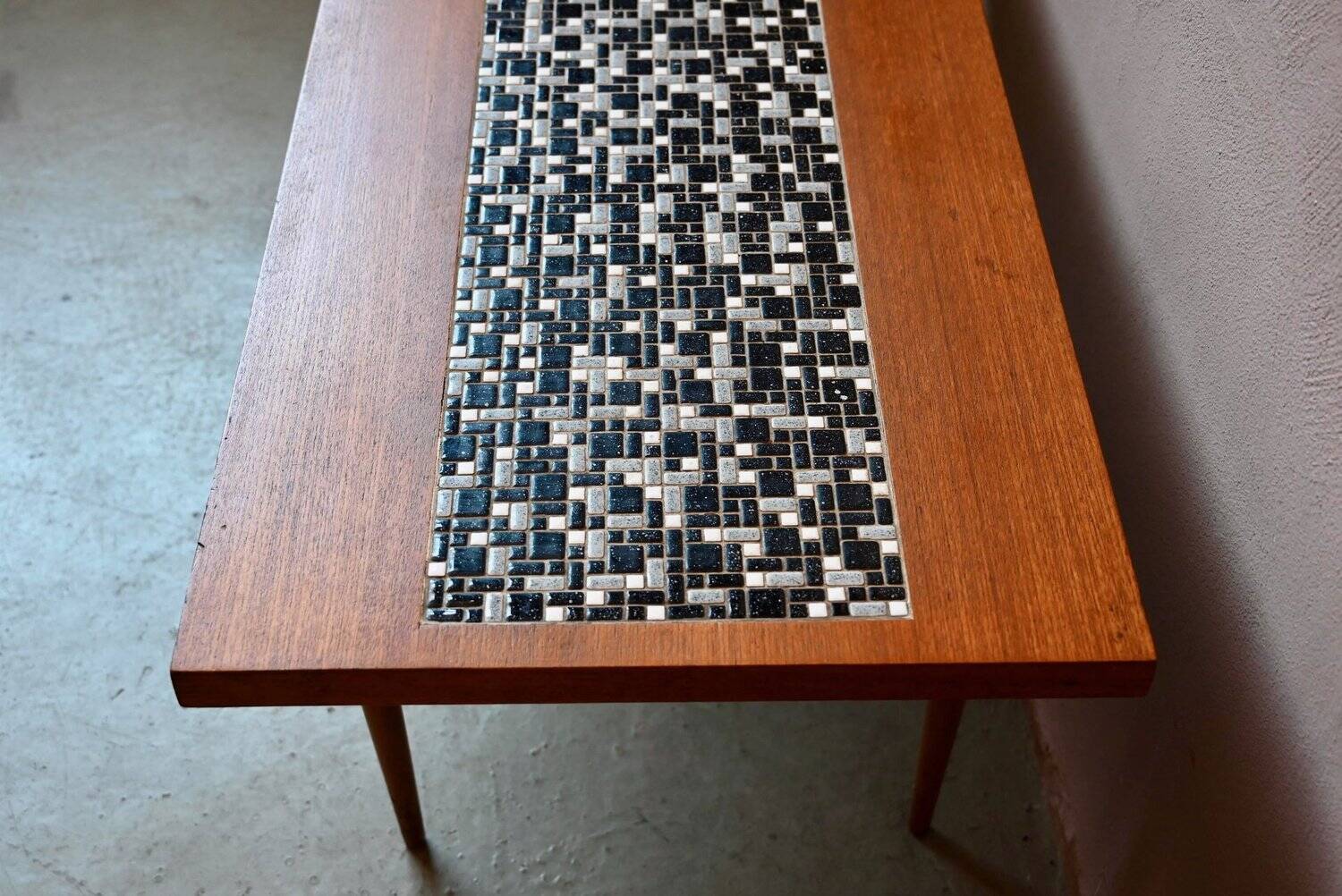1970s coffee table with a tapered teak base and ceramic mosaic.