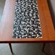 1970s coffee table with a tapered teak base and ceramic mosaic.