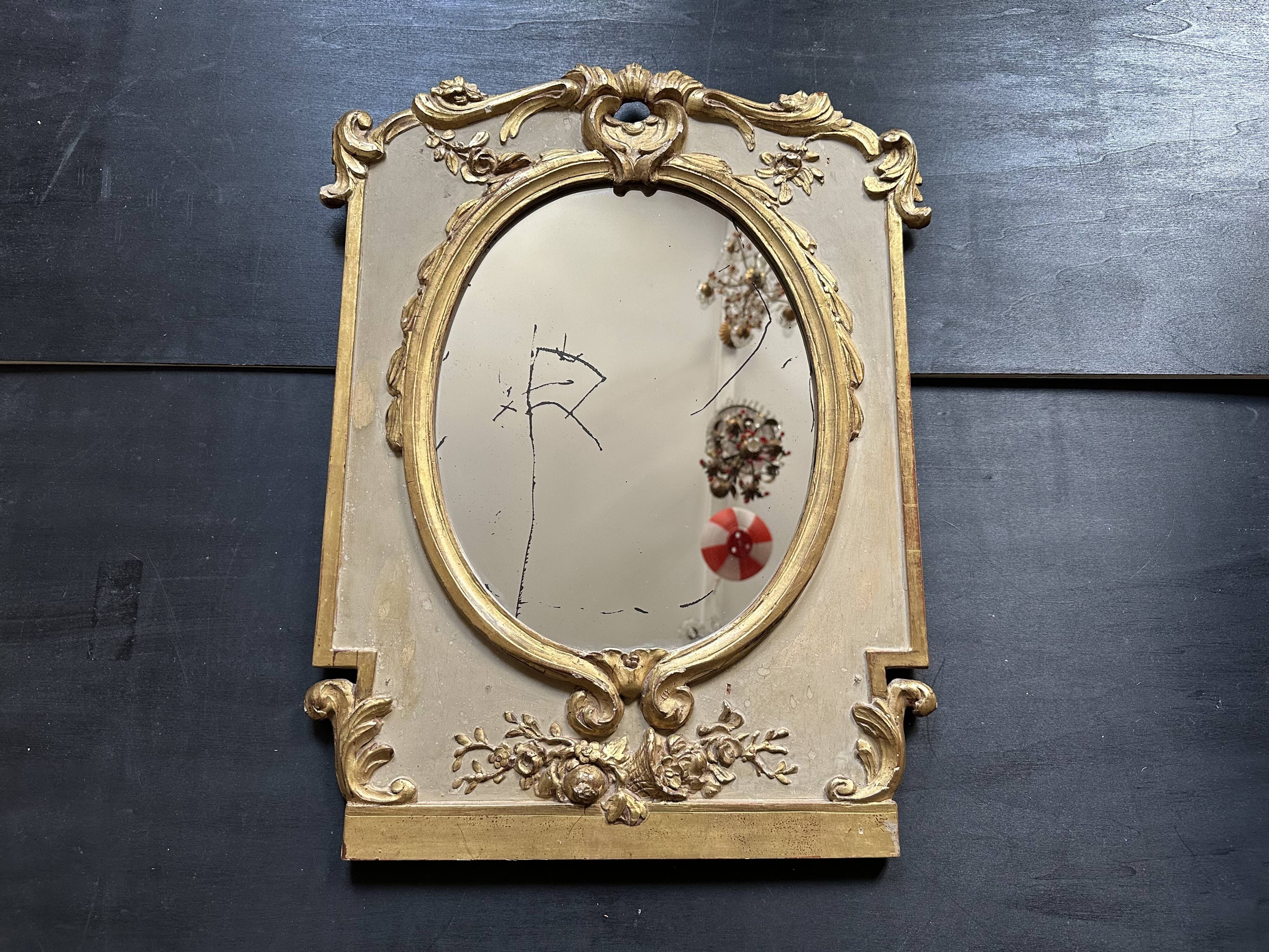 Napoleon III mirror in carved gilded wood, oval mercury glass.