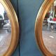 Pair of golden oval mirrors