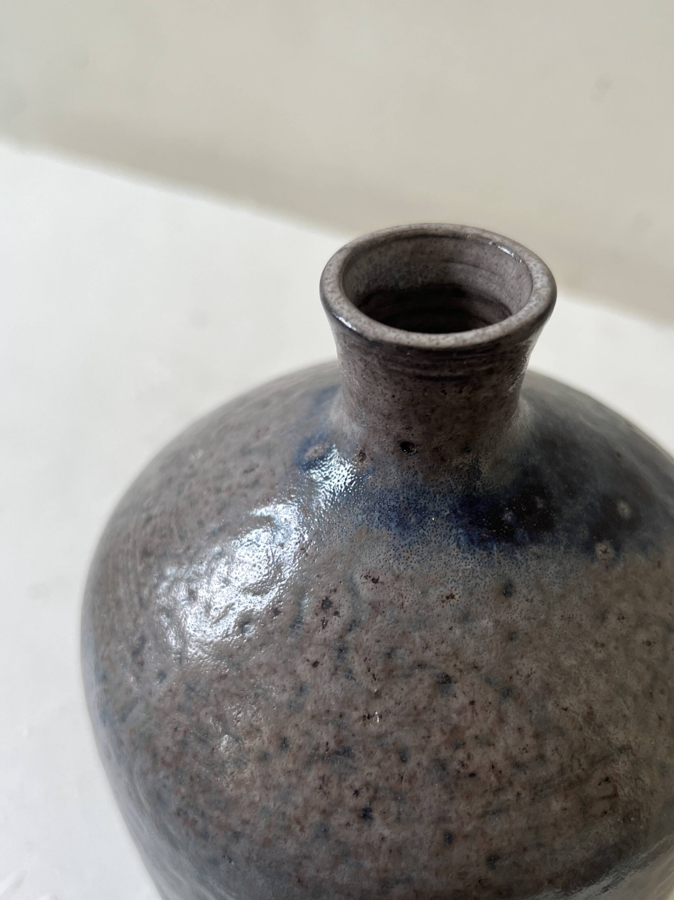 Glazed ceramic vase with a narrow neck and signed, unique piece.