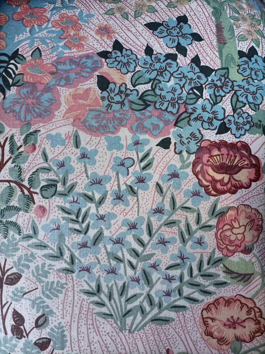 pair of toad armchairs in floral fabric.