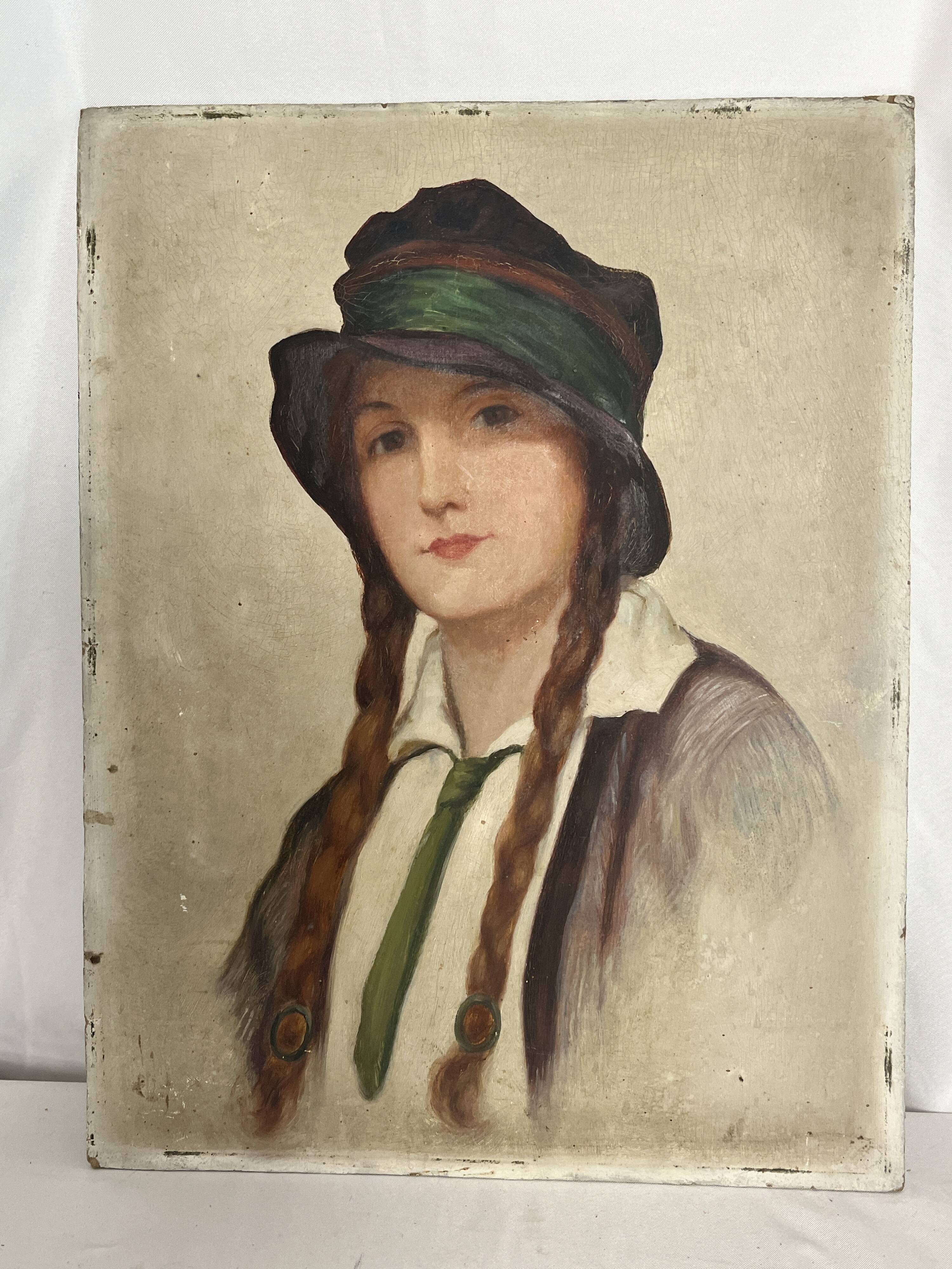 Old portrait of a young woman with braids and a hat, circa 1930