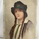 Old portrait of a young woman with braids and a hat, circa 1930
