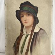 Old portrait of a young woman with braids and a hat, circa 1930