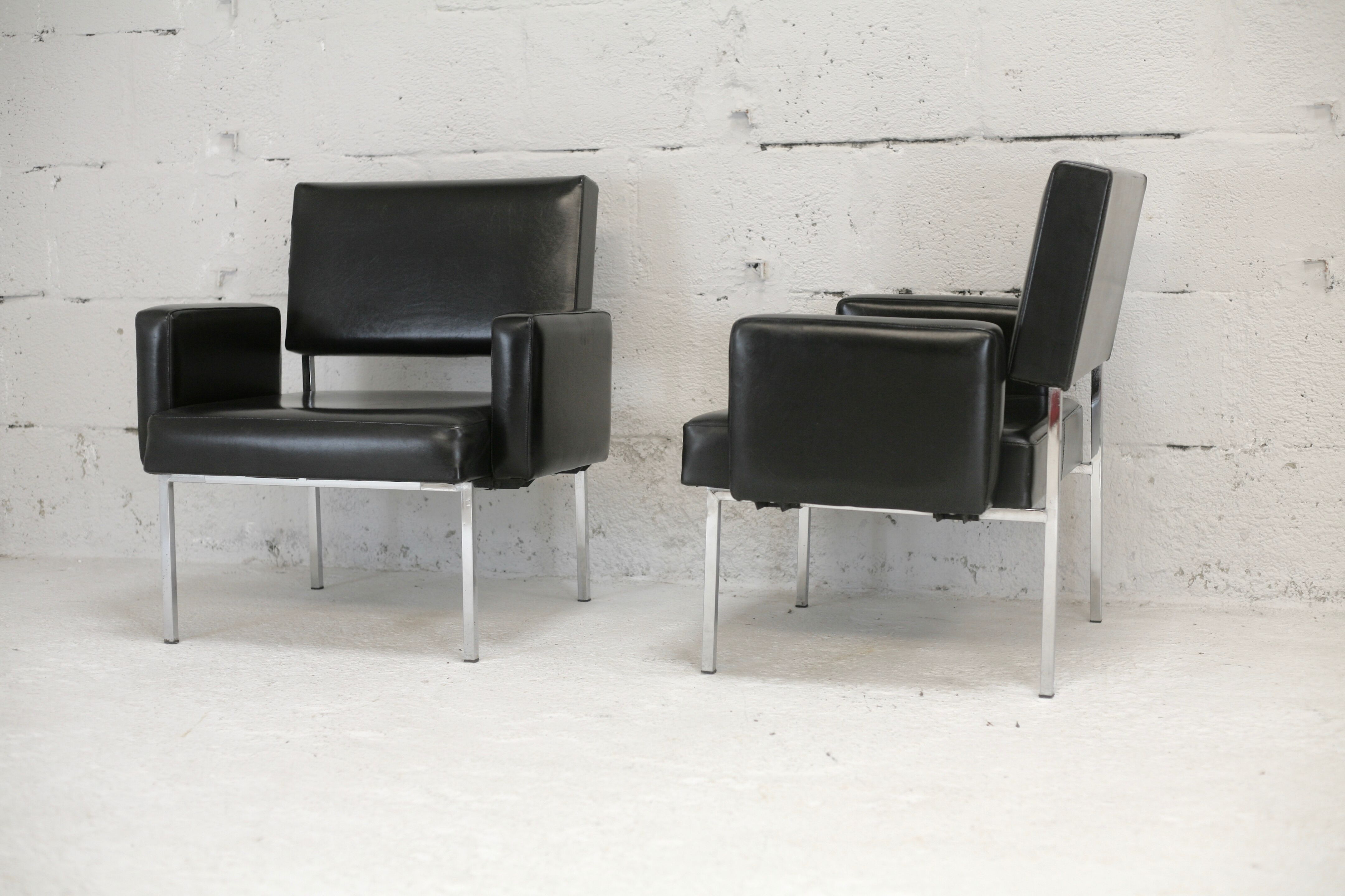 Pair of stainless steel, black leather-like armchairs, France, circa 1970