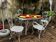 White wrought iron garden tables and chairs with mosaic.