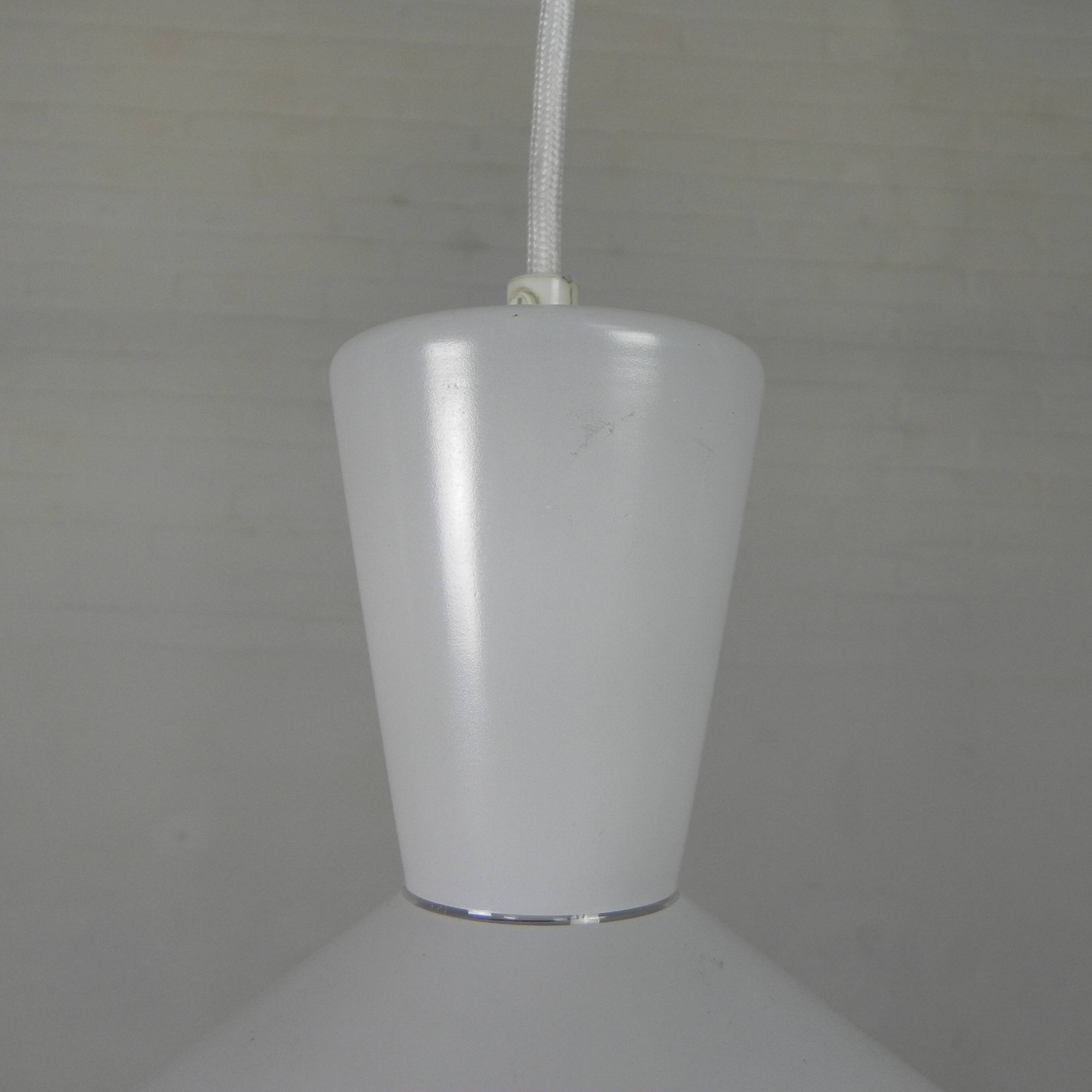 UFO-shaped pendant lamp with white glass on top and clear glass with white