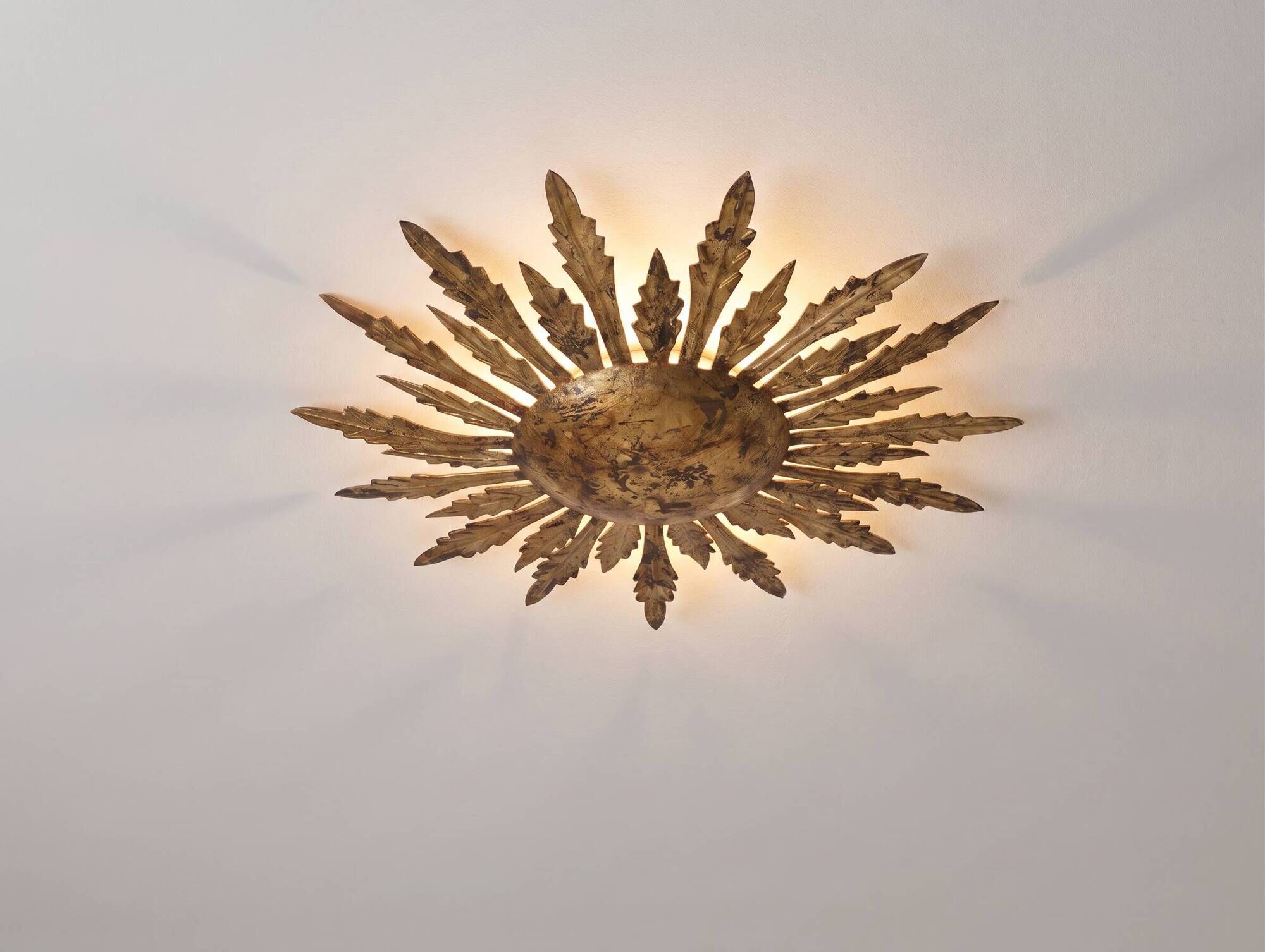 Mid-century sun ceiling lamp in gilded metal with leaf rays, 1950s