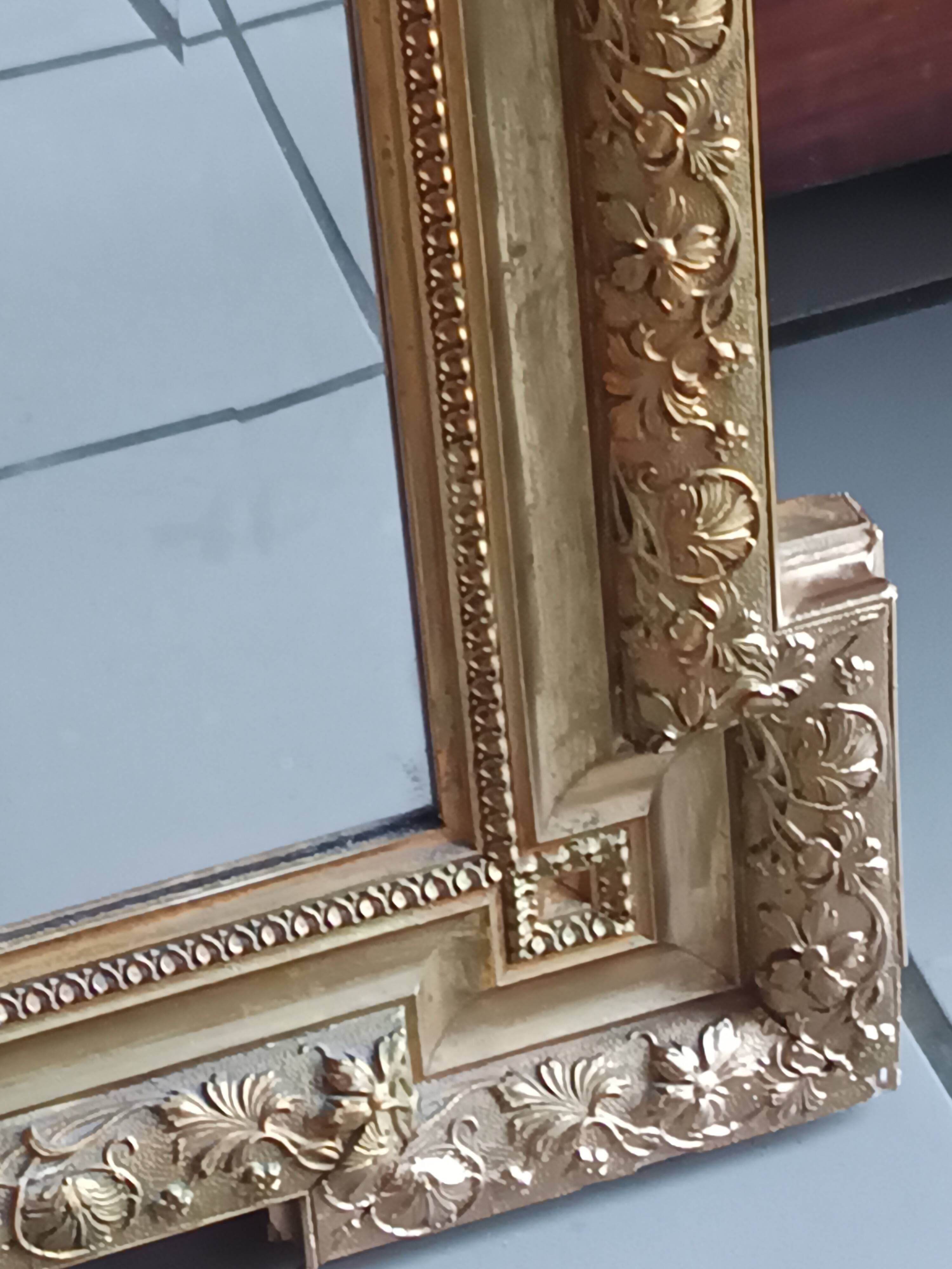 Antique mirror in wood and gilded stucco, neo Louis XVI style.