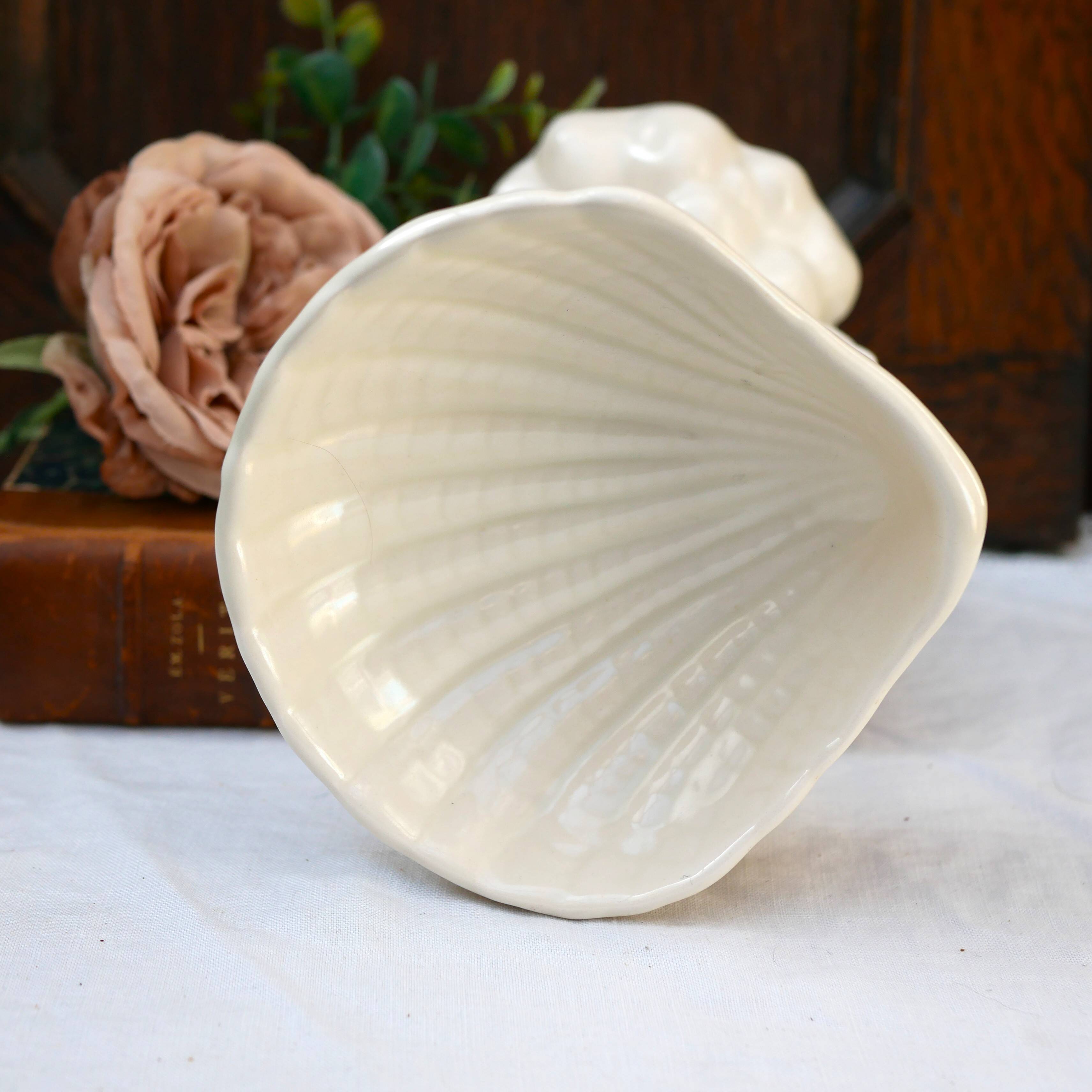 Dartmouth pottery koi carp supporting a shell-shaped dish/vase.