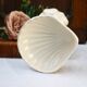 Dartmouth pottery koi carp supporting a shell-shaped dish/vase.