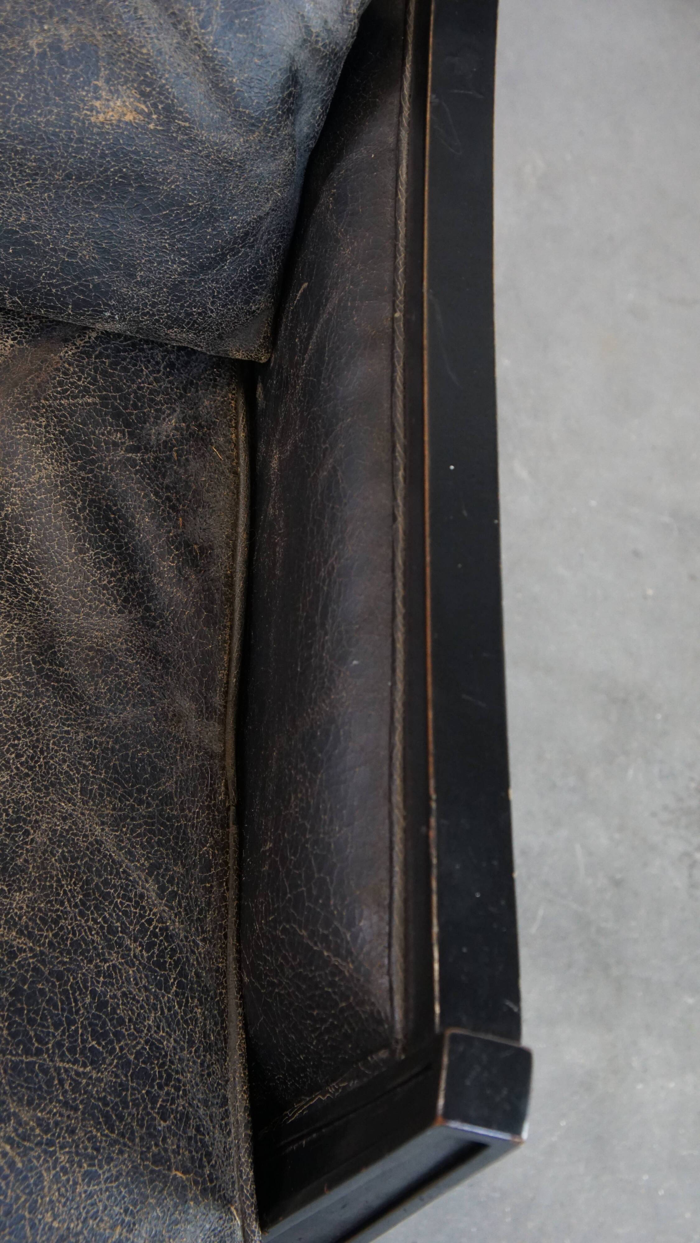 Armchair in black cowhide leather and wood with an Art Deco design