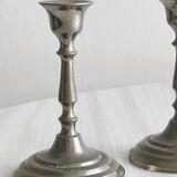 Pair of small metal candle holders, classic design.