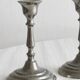 Pair of small metal candle holders, classic design.
