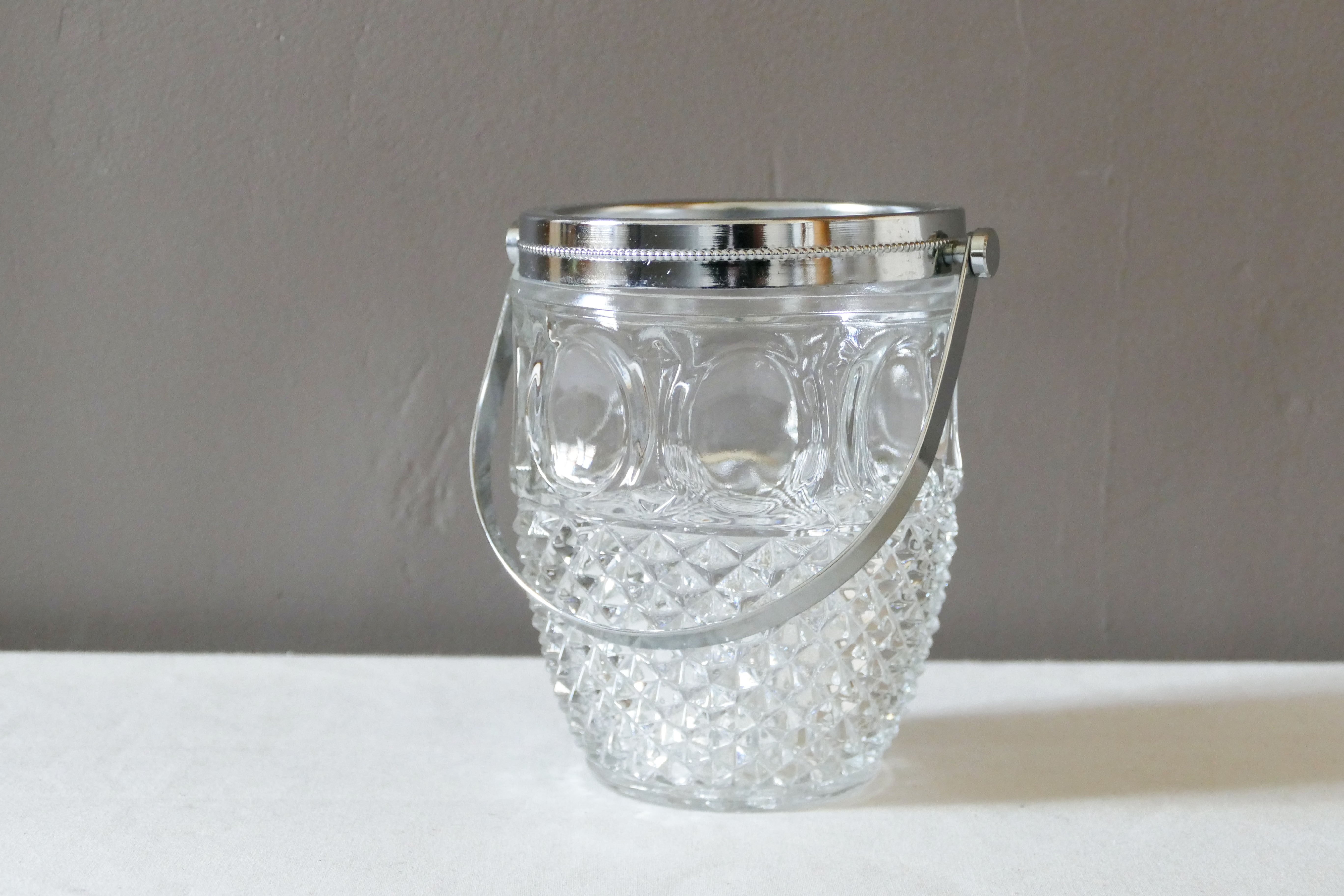 Vintage glass ice bucket stamped with a metal handle