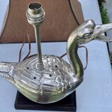 Old vintage lamp representing a duck in silver metal with wooden base