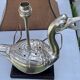 Old vintage lamp representing a duck in silver metal with wooden base