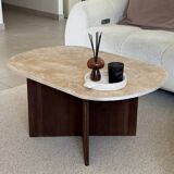 Oval coffee table in travertine and dark oak.