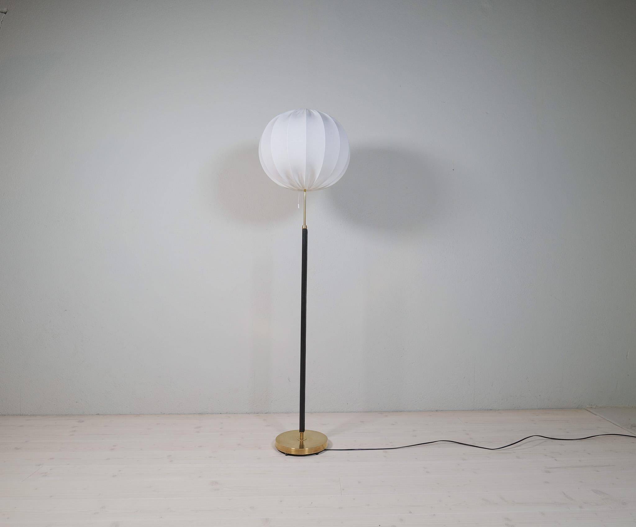 Mid-century black leather and brass floor lamp by Falkenbergs Belysning, Sweden, 1960s.