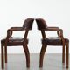 Set of two brown leather Chesterfield dining chairs in English style.