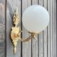 Brass "bird" wall lamp and opal globe