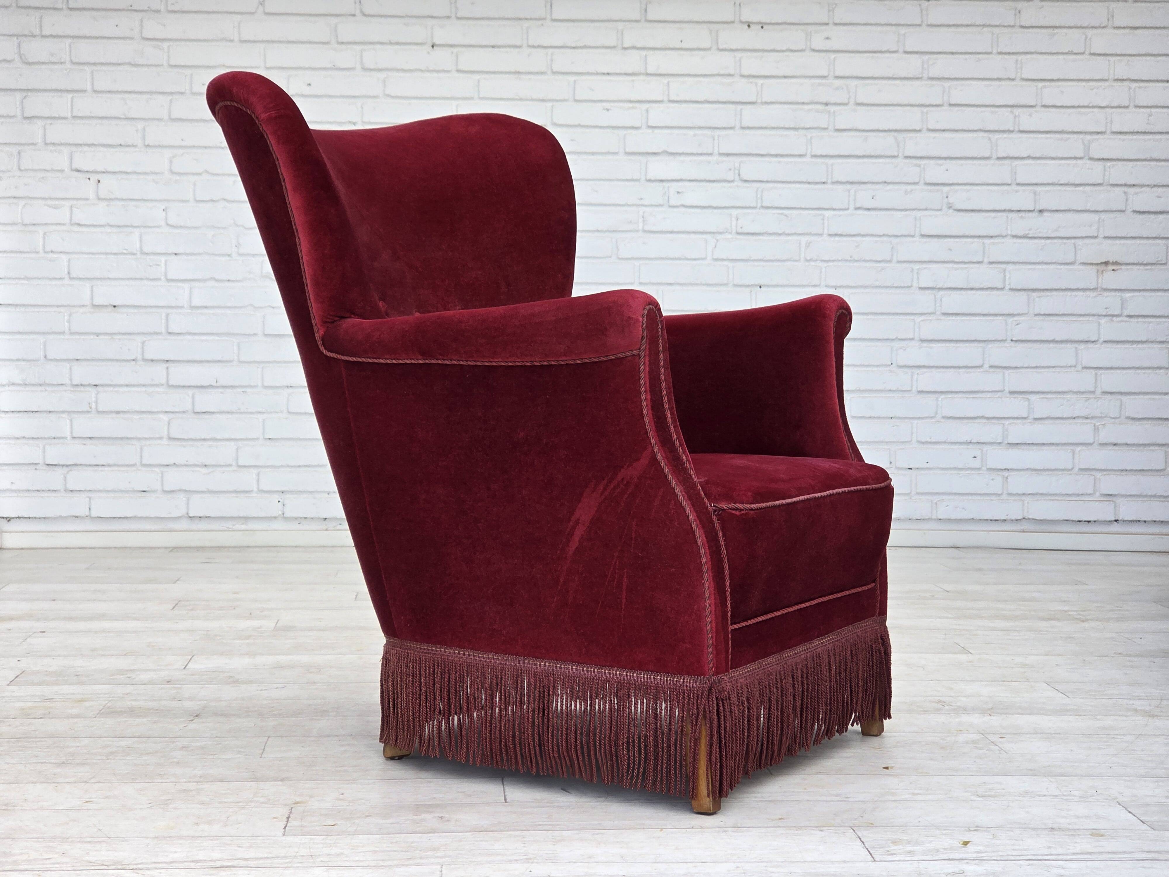 1970s, Danish armchair, cherry-red furniture velour, oak wood legs.
