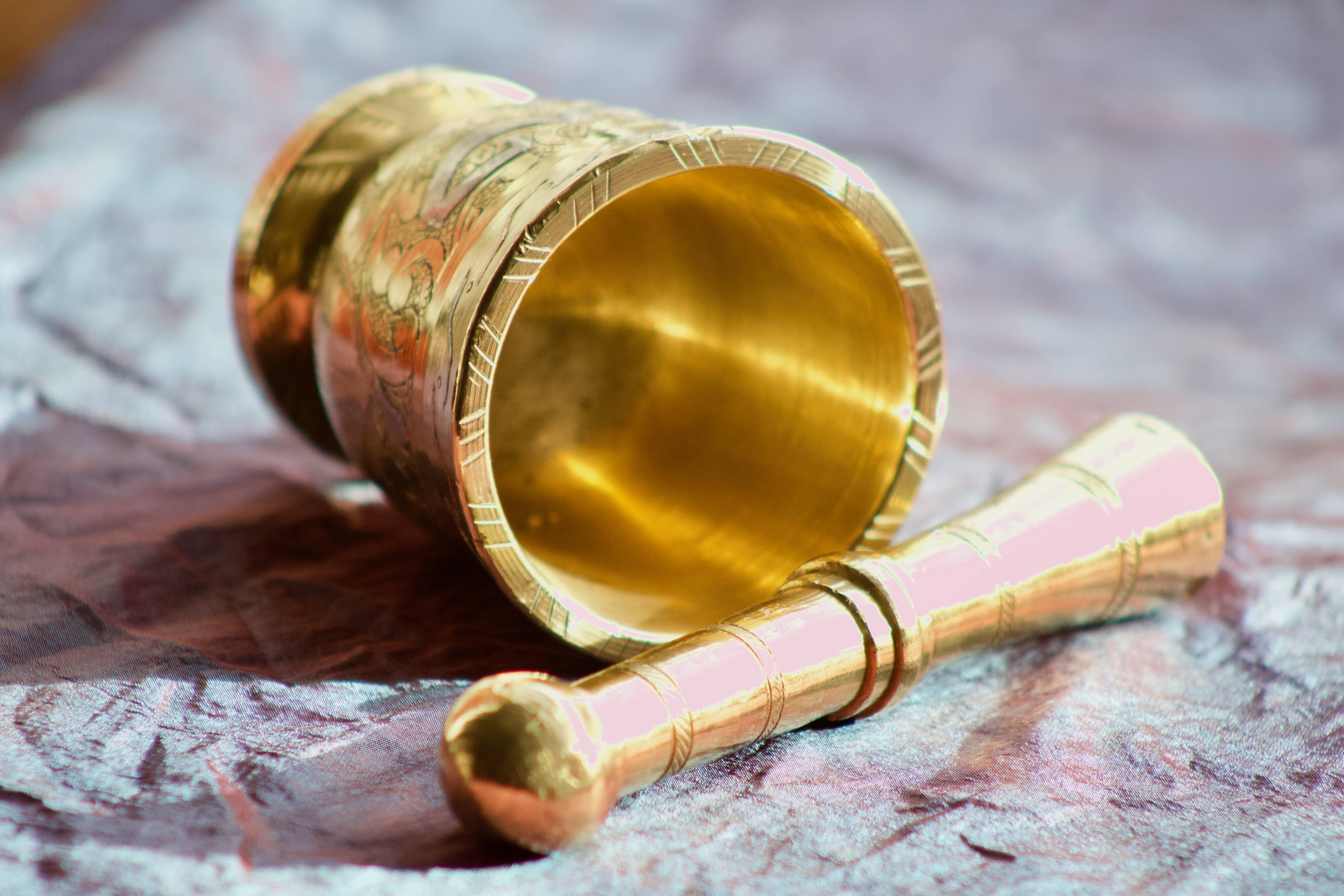 Mortar and its brass pestle with oriental gold and silver motifs
