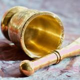 Mortar and its brass pestle with oriental gold and silver motifs