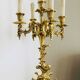 Massive gilded bronze chandeliers from the mid-20th century with marble bases.